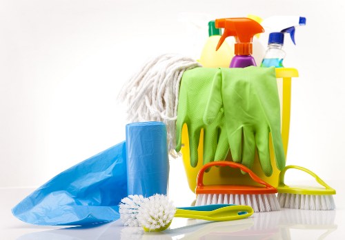 Upholstery cleaner working on a sofa in a Belsize Park property